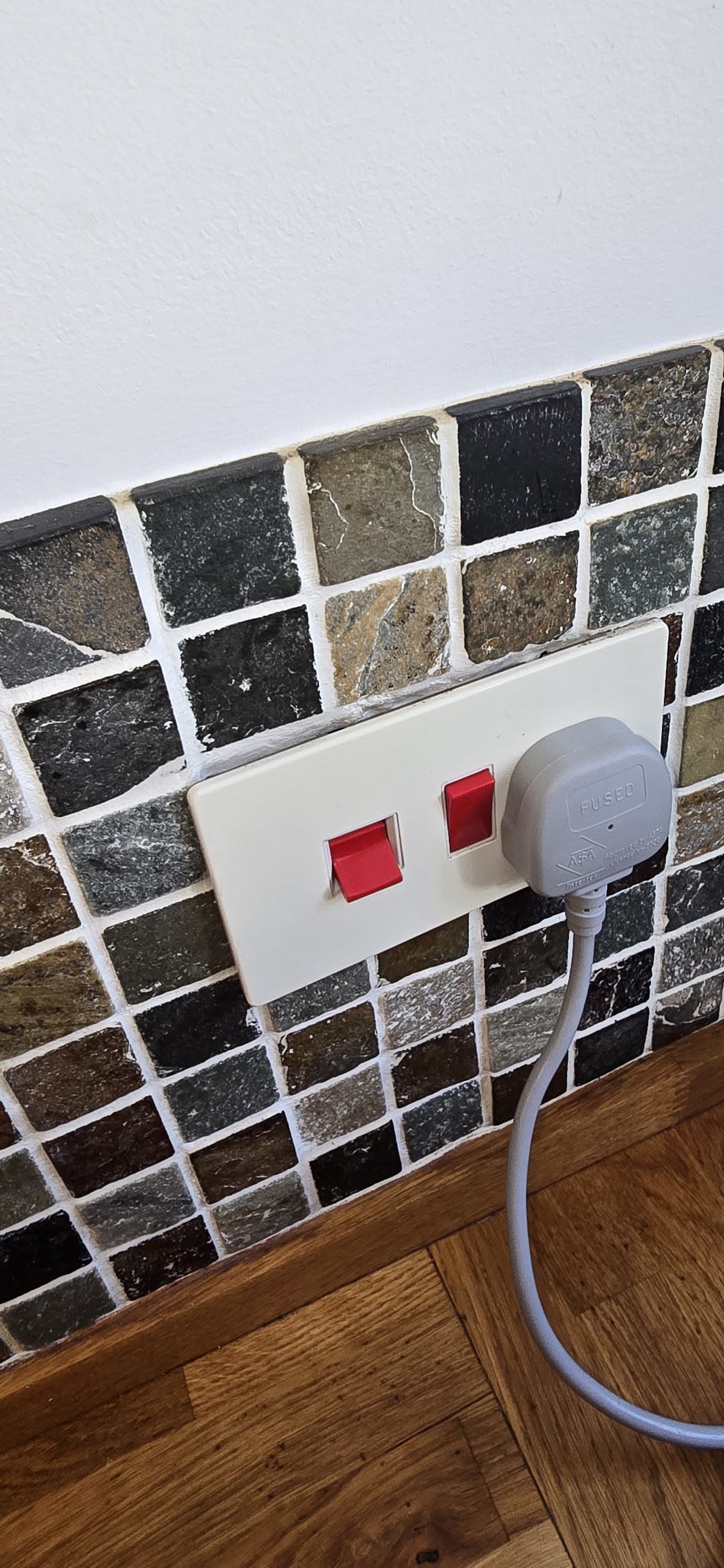 A freshly cleaned tiled splashback and kitchen surfaces